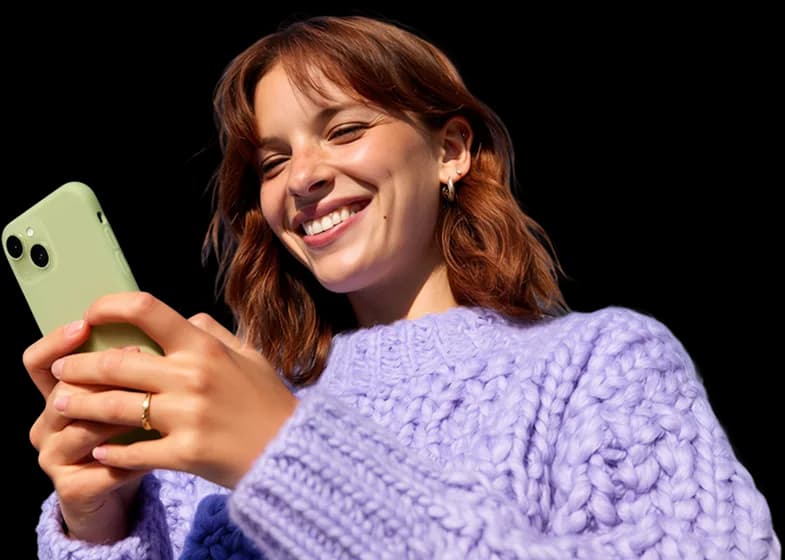 Customer smiling at a phone after checking her tax refund